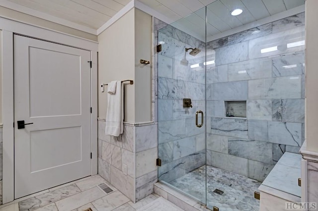 bathroom featuring a shower with shower door