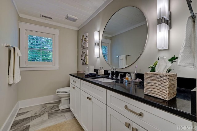 bathroom featuring toilet, vanity, and ornamental molding