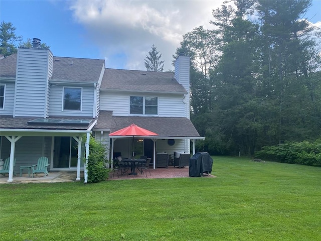 711 Horse Cove Rd Unit C-4, Highlands, NC 28741 - back of property with a chimney, a patio, a yard, and roof with shingles