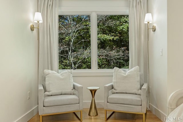 sitting room featuring hardwood / wood-style flooring and plenty of natural light