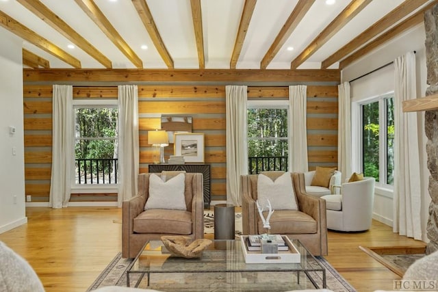 sunroom with a wealth of natural light and beam ceiling