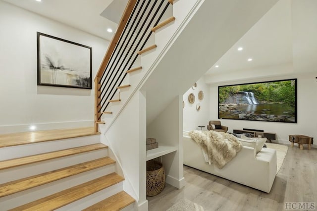 stairs featuring hardwood / wood-style floors