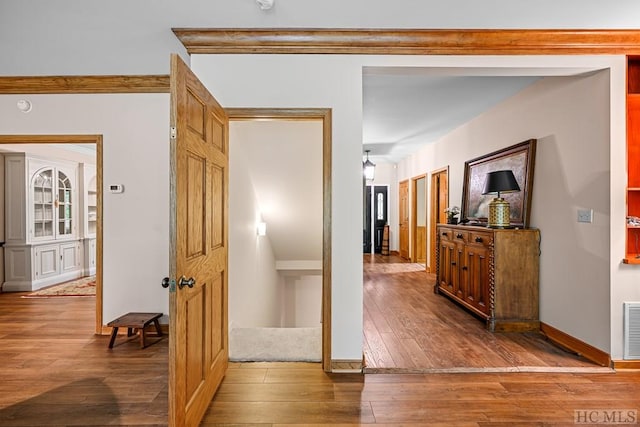 hallway with hardwood / wood-style floors