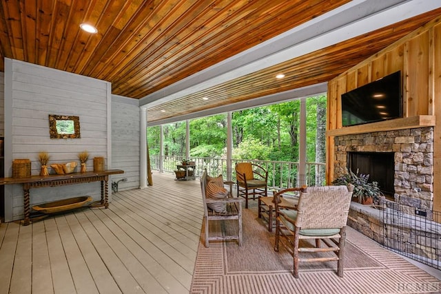 interior space with wood ceiling, a fireplace, and plenty of natural light