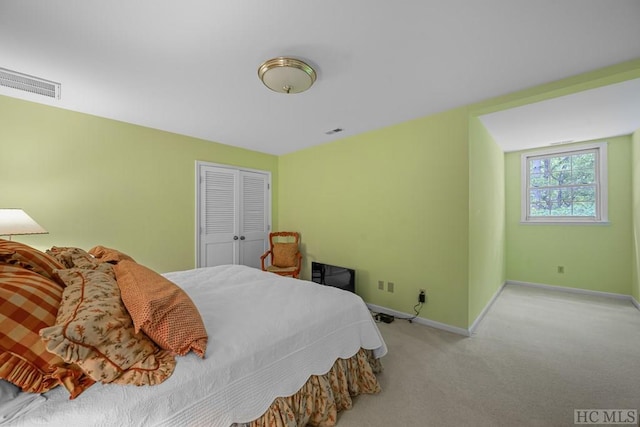 bedroom with light carpet and a closet