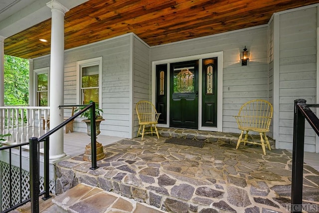 view of exterior entry featuring a porch