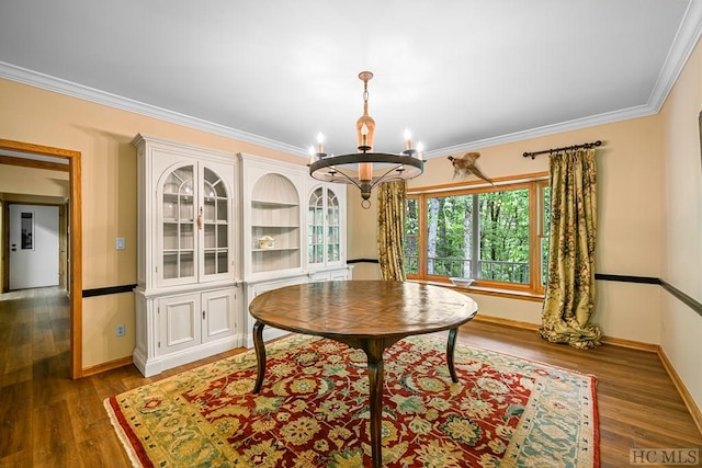 dining area with a notable chandelier, crown molding, and dark hardwood / wood-style floors