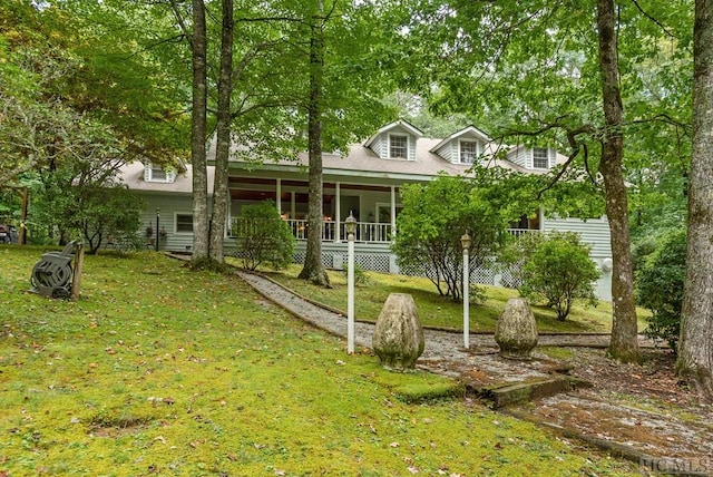 view of front of house featuring a sunroom and a front yard