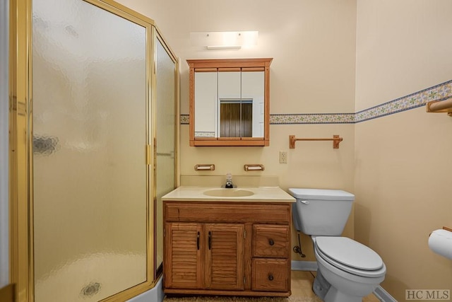 bathroom featuring vanity, an enclosed shower, tile patterned floors, and toilet