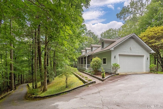 view of property exterior featuring a garage and a sunroom