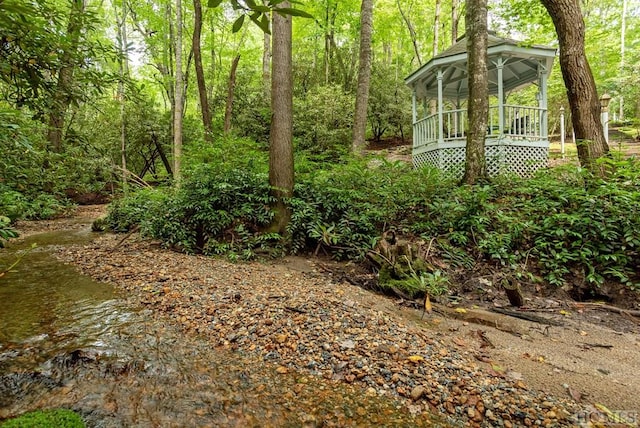 view of yard featuring a gazebo and a water view