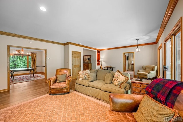 living room with ornamental molding and light hardwood / wood-style flooring