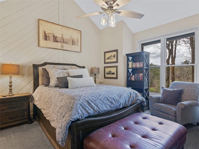 carpeted bedroom featuring wooden walls, ceiling fan, and vaulted ceiling