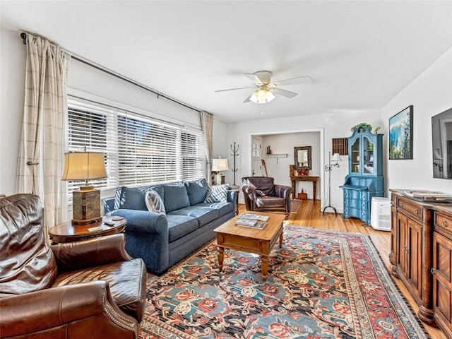 living room featuring ceiling fan and light hardwood / wood-style flooring