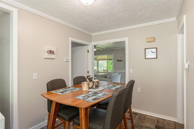 dining space featuring a textured ceiling, crown molding, ceiling fan, and baseboards