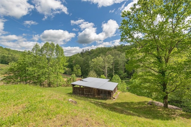 view of subject property with a heavily wooded area
