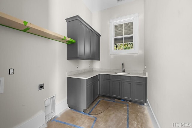 washroom featuring cabinets, sink, and electric dryer hookup