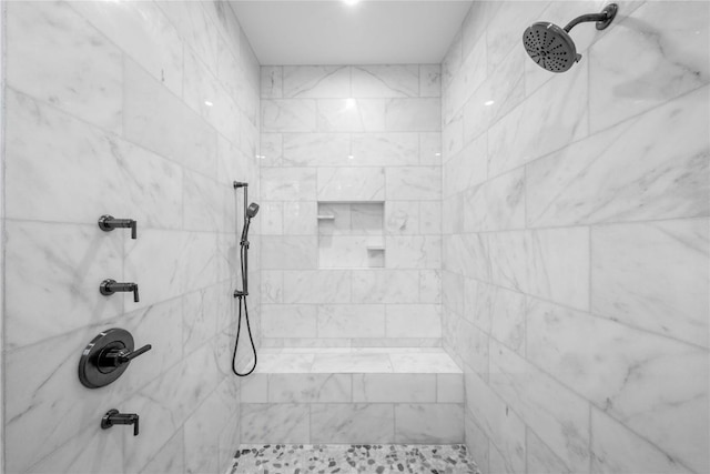 full bath featuring tiled shower