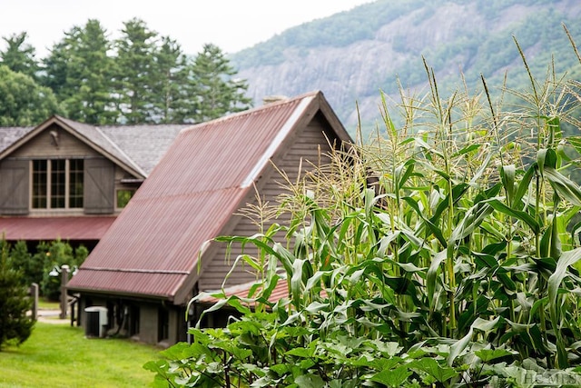 view of home's exterior with a mountain view and central AC