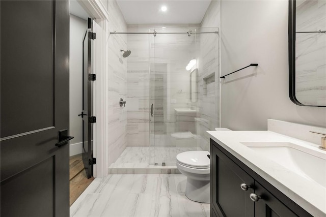 full bath with marble finish floor, a shower stall, toilet, and vanity