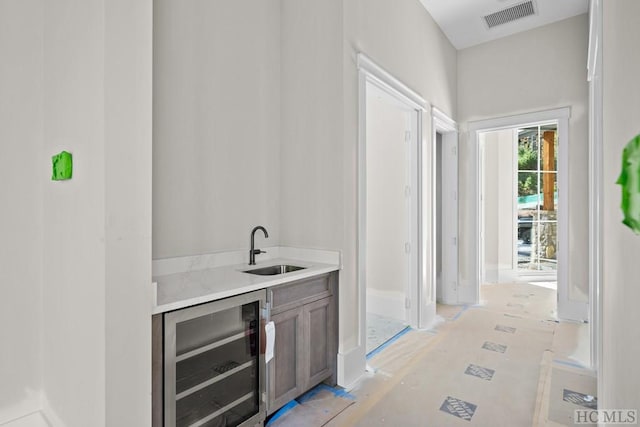 bar with wine cooler and sink