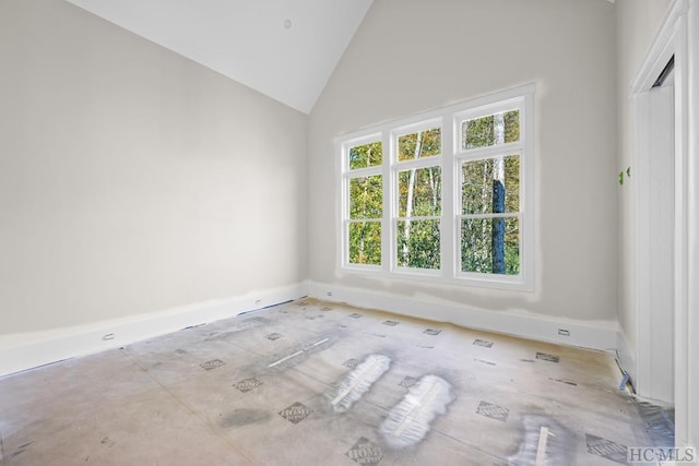 unfurnished room featuring high vaulted ceiling