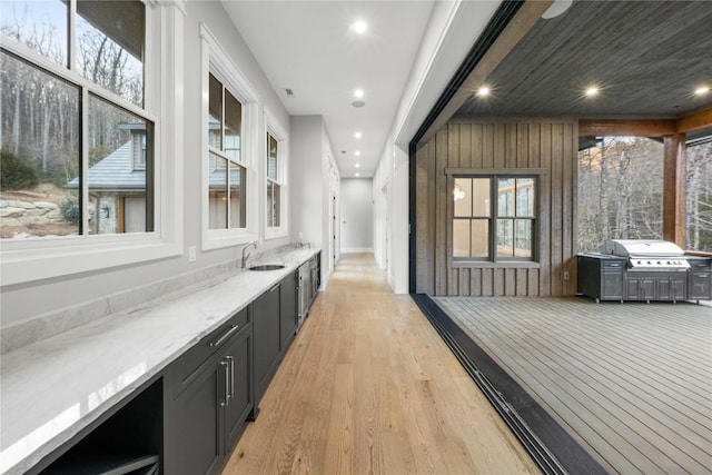 bar with recessed lighting, a sink, and light wood-style floors