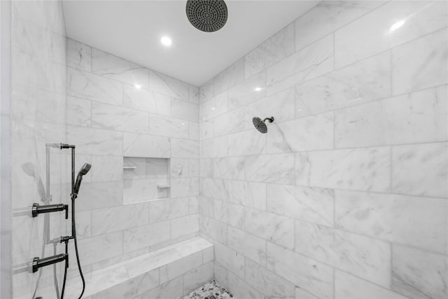 bathroom with a tile shower