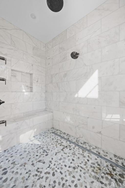 bathroom with a tile shower