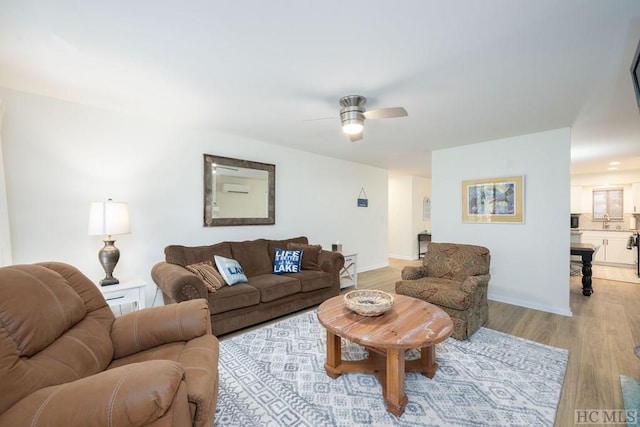 living room featuring ceiling fan and light wood-type flooring