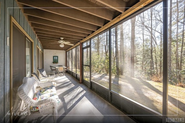 unfurnished sunroom with ceiling fan