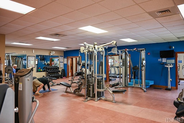 workout area featuring a paneled ceiling