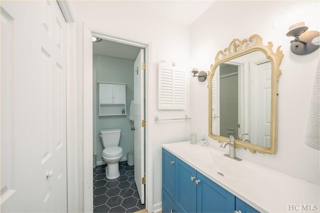 bathroom featuring toilet and vanity