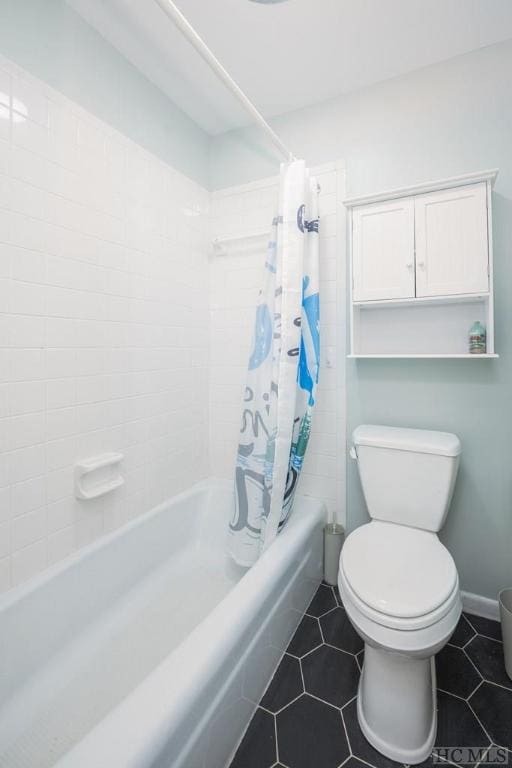 bathroom featuring toilet, tile patterned floors, and shower / bath combo with shower curtain