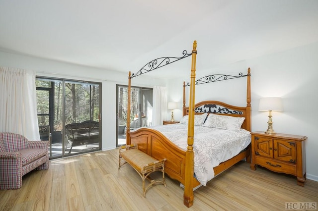 bedroom featuring light wood-type flooring and access to exterior