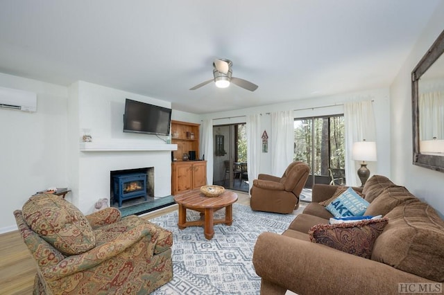 living room featuring ceiling fan, light hardwood / wood-style flooring, and a wall mounted air conditioner