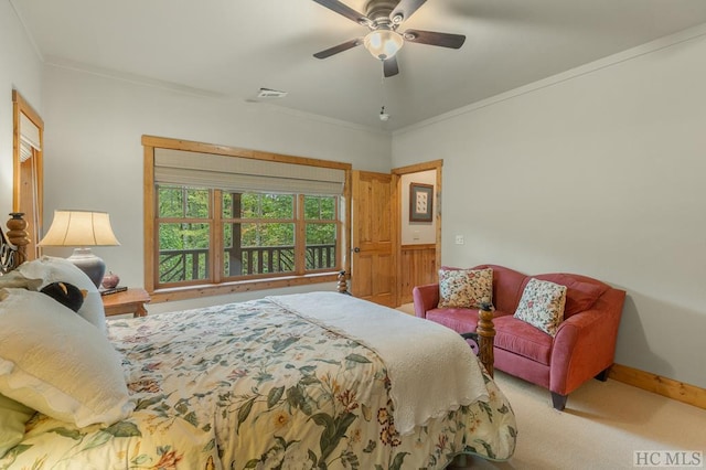 carpeted bedroom with ornamental molding and ceiling fan