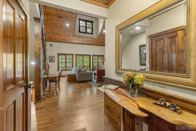 interior space featuring wood ceiling, light hardwood / wood-style flooring, and high vaulted ceiling