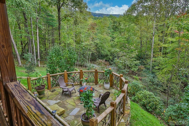 wooden terrace with a patio area