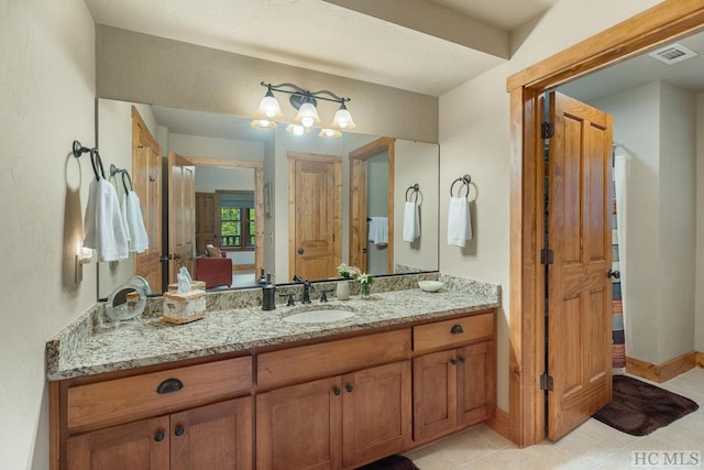 bathroom with tile patterned flooring and vanity