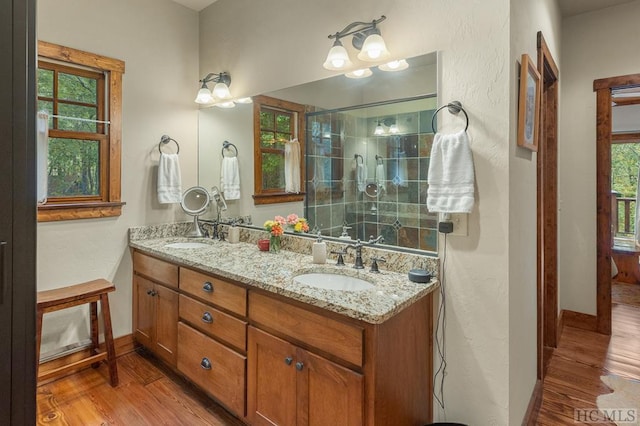 bathroom featuring vanity, tiled shower, and hardwood / wood-style floors