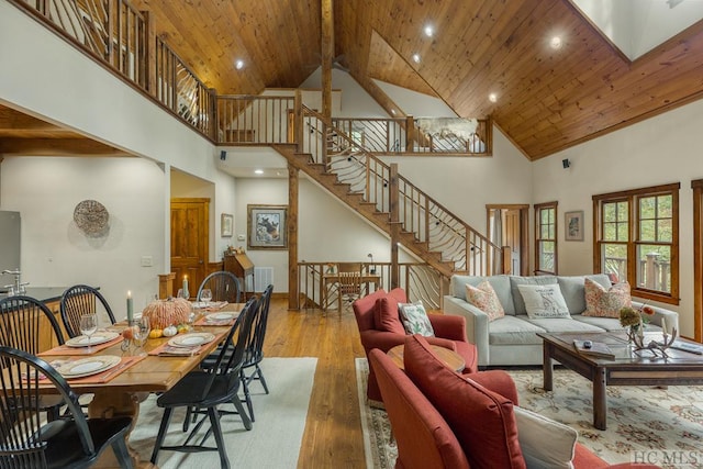 living room with wood ceiling, high vaulted ceiling, and light wood-type flooring