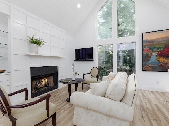 49 Kiwi Ln Unit 14, Sapphire, NC 28774 - living room featuring high vaulted ceiling, a lit fireplace, light wood finished floors, and wood ceiling