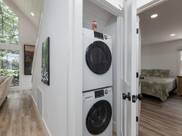 49 Kiwi Ln Unit 14, Sapphire, NC 28774 - laundry room featuring stacked washer / dryer, light wood-style flooring, and recessed lighting