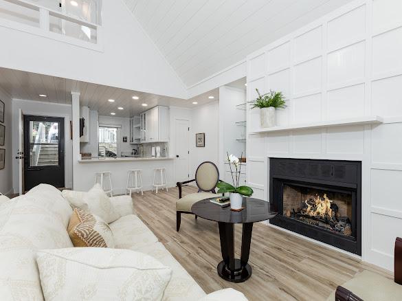49 Kiwi Ln Unit 14, Sapphire, NC 28774 - living area with light wood-style floors, vaulted ceiling, a lit fireplace, wood ceiling, and recessed lighting