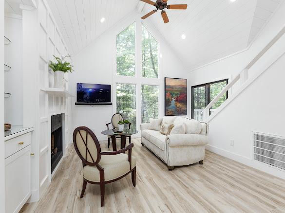 49 Kiwi Ln Unit 14, Sapphire, NC 28774 - living area with high vaulted ceiling, a fireplace, light wood-style floors, a ceiling fan, and recessed lighting