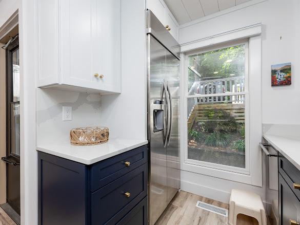 49 Kiwi Ln Unit 14, Sapphire, NC 28774 - kitchen with stainless steel built in fridge, light wood finished floors, white cabinetry, and light countertops