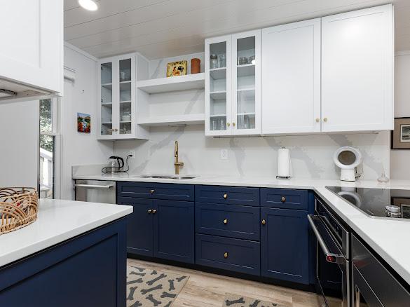 49 Kiwi Ln Unit 14, Sapphire, NC 28774 - kitchen featuring blue cabinets, stainless steel appliances, white cabinetry, and light countertops