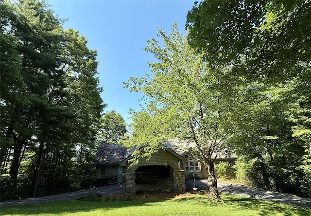 258 Club Colony Ln, Lake Toxaway, NC 28747 - view of green lawn with asphalt driveway and an attached garage