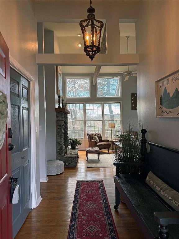258 Club Colony Ln, Lake Toxaway, NC 28747 - foyer entrance featuring a towering ceiling, a chandelier, wood finished floors, and a ceiling fan